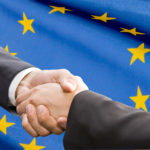 Handshake over EU flag. Partnership and  politics concept